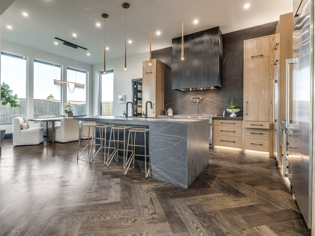 Modern home kitchen with sleek stone island and open dining area