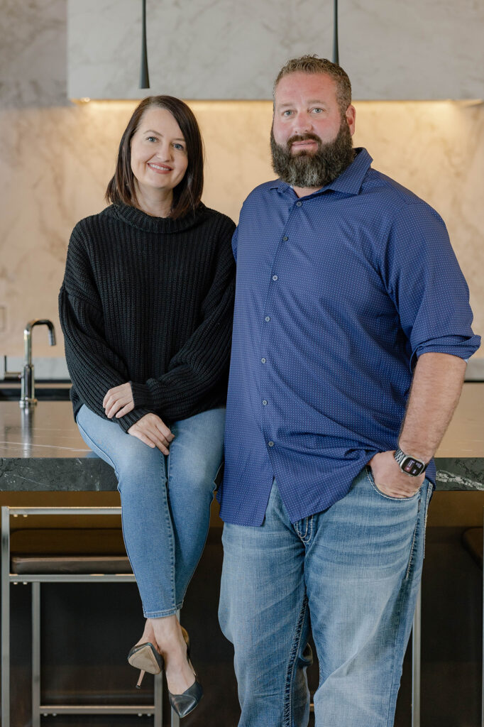 Owners of Huffman Custom Homes, a leading Oklahoma Home Builder, standing together in a modern kitchen.
