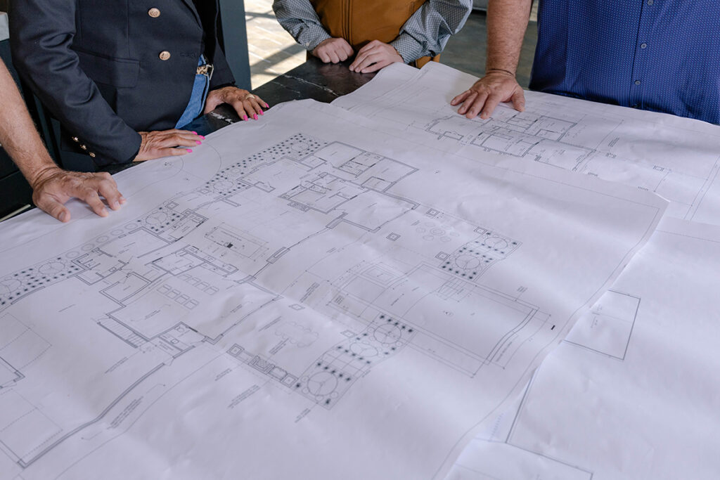 Floor plans being reviewed for custom OKC homes during a design meeting